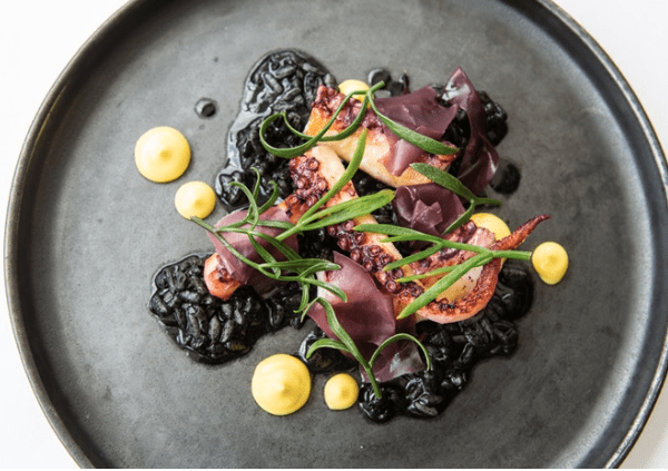 Grilled Octopus on a Black Plate